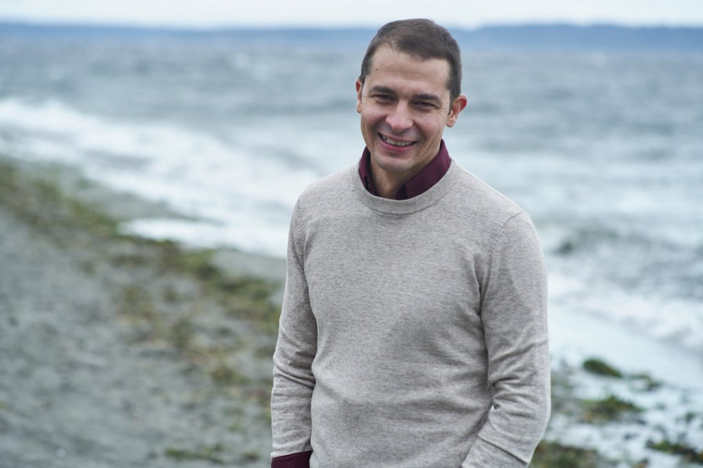 Gabe Cisneros standing on a Puget Sound beach
